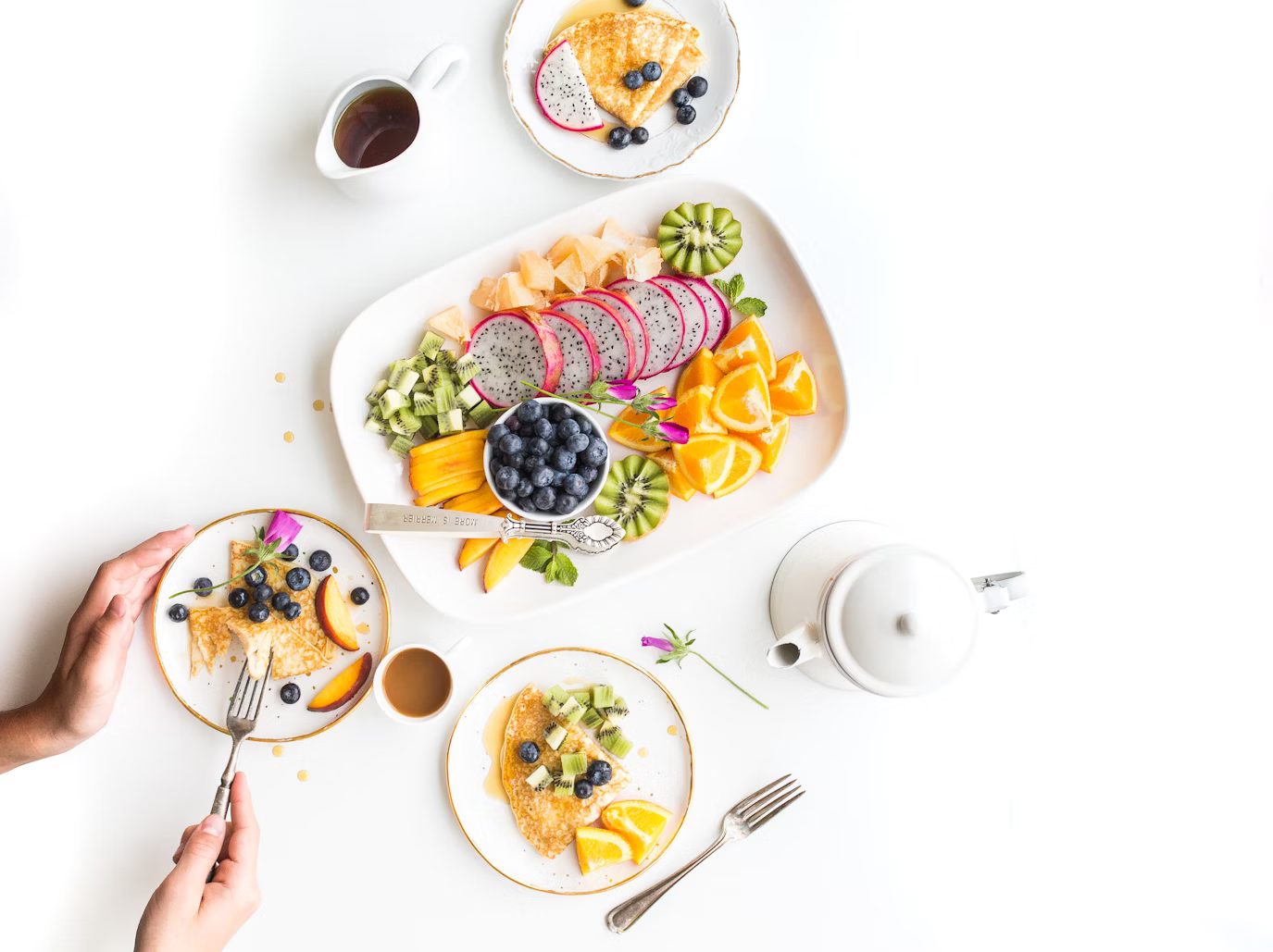 White dishes on a white background containing healthy food
