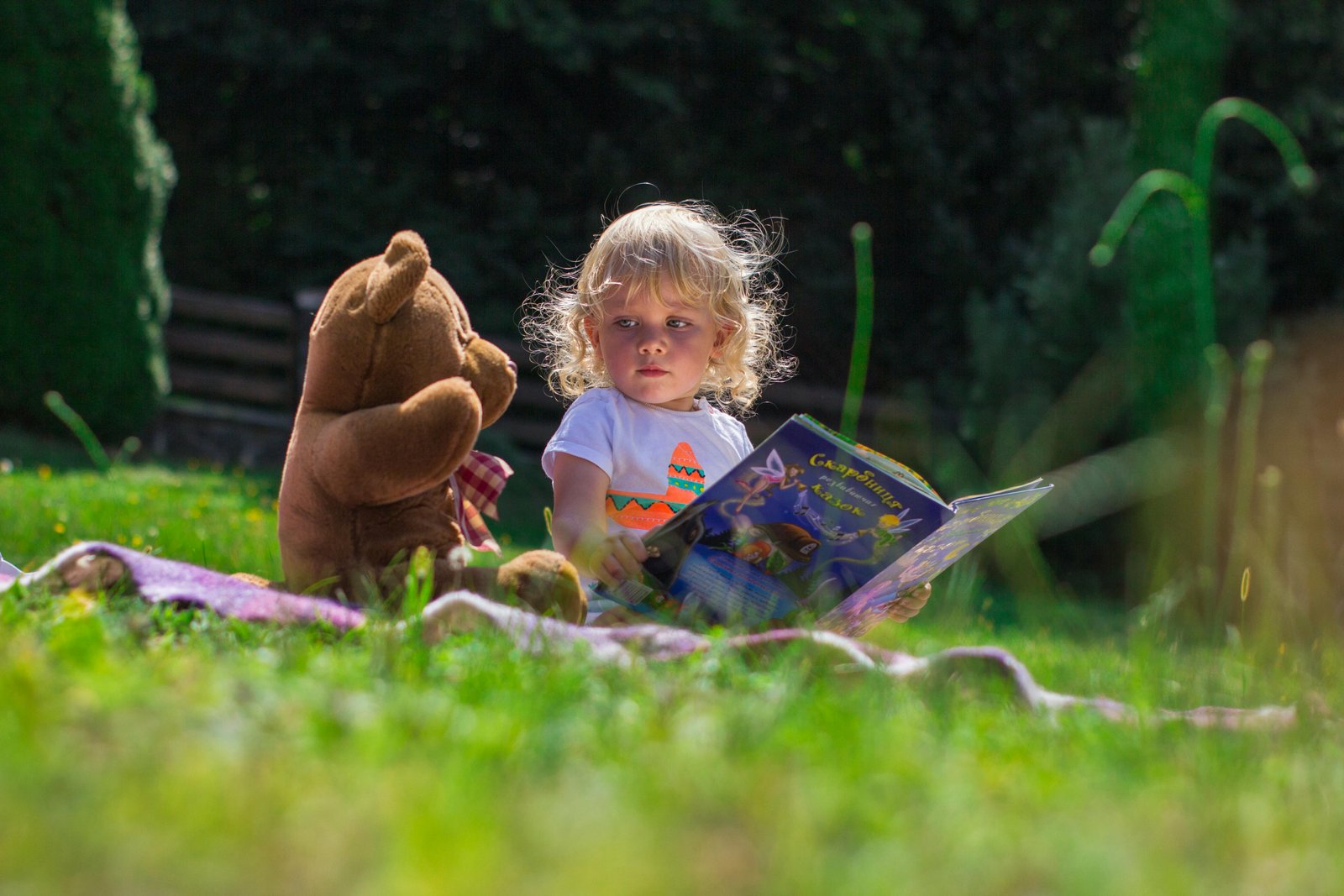 A healthy and adorable baby girl sitting in the garden.